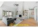 Bright living room with stone fireplace, built-in shelving, and hardwood floors at 110 Broadleaf Ln, Louisburg, NC 27549