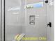Beautiful tile shower with built-in shelving, a bench, and a shower head at 110 Broadleaf Ln, Louisburg, NC 27549