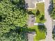 Aerial shot of the yellow home, surrounded by lush greenery and neighboring houses in a quiet neighborhood at 11901 N North Exeter Way Way, Raleigh, NC 27613