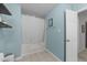 Bathroom featuring a tub with shower, tile flooring, and a white door at 11901 N North Exeter Way Way, Raleigh, NC 27613