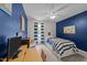 Nautical themed bedroom featuring blue walls, a striped bedspread and a desk area at 11901 N North Exeter Way Way, Raleigh, NC 27613