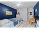 Bedroom featuring blue accent walls, storage bed with shark bedding, and work desk at 11901 N North Exeter Way Way, Raleigh, NC 27613