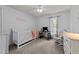 Bedroom featuring white walls, carpet, a white crib, and desk at 11901 N North Exeter Way Way, Raleigh, NC 27613
