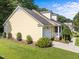 Charming yellow home with a well-manicured lawn, inviting front porch, and attached single car garage at 11901 N North Exeter Way Way, Raleigh, NC 27613