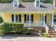 Close-up of a home's facade featuring a decorative white porch railing and brick steps at 11901 N North Exeter Way Way, Raleigh, NC 27613