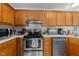 Well-lit kitchen featuring stainless steel appliances, oak cabinets, and white countertops at 11901 N North Exeter Way Way, Raleigh, NC 27613