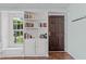 An interior entryway is highlighted by a built-in bookcase and hardwood floors at 11901 N North Exeter Way Way, Raleigh, NC 27613