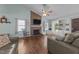 Bright, spacious living room with a brick fireplace, vaulted ceiling, and hardwood flooring at 11901 N North Exeter Way Way, Raleigh, NC 27613