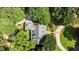Aerial view of a home with lush landscaping, circular driveway, and a private setting at 12201 Lockhart Ln, Raleigh, NC 27614