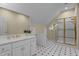 Bathroom features white cabinets, gold fixtures, and a glass shower with a bright window at 12201 Lockhart Ln, Raleigh, NC 27614