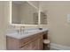 Bright bathroom with a vanity and stool, plus an illuminated mirror and cabinets at 12201 Lockhart Ln, Raleigh, NC 27614