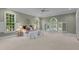 Large bedroom with carpet, many windows with shutters, and a decorative ceiling fan at 12201 Lockhart Ln, Raleigh, NC 27614