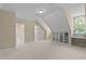 Large bonus room with a built in desk and bright light from an arched window at 12201 Lockhart Ln, Raleigh, NC 27614