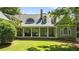 Beautiful traditional home featuring a brick porch and a light green exterior at 12201 Lockhart Ln, Raleigh, NC 27614