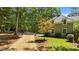 A beautiful home exterior with a gravel driveway and lush green landscaping at 12201 Lockhart Ln, Raleigh, NC 27614