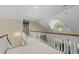 Bright hallway features white railings, arched window, and views overlooking the living room below at 12201 Lockhart Ln, Raleigh, NC 27614