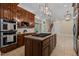 Gourmet kitchen featuring center island and double ovens at 12201 Lockhart Ln, Raleigh, NC 27614