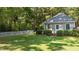 Backyard outbuilding with white trim, picket fence, and manicured lawn at 12201 Lockhart Ln, Raleigh, NC 27614