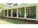 Lovely exterior porch featuring white columns, brick steps, and outdoor seating area at 12201 Lockhart Ln, Raleigh, NC 27614
