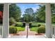 View of landscaped front yard through front porch columns at 12201 Lockhart Ln, Raleigh, NC 27614
