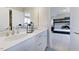 Bright bathroom featuring double sinks, quartz countertops, white cabinets, and access to the bedroom at 124 Seagraves Creek Ln, Holly Springs, NC 27540