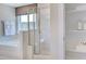 This full bathroom features a white tub, a glass enclosed shower, and a built-in shelf at 124 Seagraves Creek Ln, Holly Springs, NC 27540