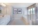 This full bathroom is equipped with double sinks, a large tub, and a tiled walk-in shower at 124 Seagraves Creek Ln, Holly Springs, NC 27540
