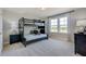 Comfortable bedroom features bunk beds, neutral colors, window, and modern furnishings at 124 Seagraves Creek Ln, Holly Springs, NC 27540