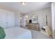 Spacious bedroom with a dresser, pet tent, and a glimpse into the adjoining bathroom at 124 Seagraves Creek Ln, Holly Springs, NC 27540