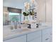 The bathroom features a double vanity, chrome fixtures, and decorative elements at 124 Seagraves Creek Ln, Holly Springs, NC 27540