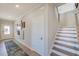 Inviting foyer with hardwood floors, white trim, and staircase to the second floor at 124 Seagraves Creek Ln, Holly Springs, NC 27540