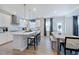 Well-lit eat-in kitchen boasting modern appliances, a stylish island, and a cozy dining space at 124 Seagraves Creek Ln, Holly Springs, NC 27540