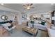 Bright open-plan living room with modern decor, flowing seamlessly into dining and kitchen areas at 124 Seagraves Creek Ln, Holly Springs, NC 27540