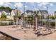 Community playground featuring climbing equipment near residential homes at 124 Seagraves Creek Ln, Holly Springs, NC 27540