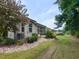 Lush backyard featuring the house, screened in porch and manicured lawn at 12421 Angel Vale Pl, Durham, NC 27703