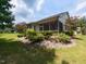 Well-maintained backyard showcasing the exterior of the house with screened porch at 12421 Angel Vale Pl, Durham, NC 27703
