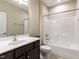 Well-lit bathroom boasts a clean aesthetic with a modern vanity, toilet, and a shower-tub combo at 12421 Angel Vale Pl, Durham, NC 27703