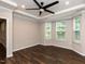 Inviting bedroom features a ceiling fan, tray ceiling, natural light and neutral decor at 12421 Angel Vale Pl, Durham, NC 27703