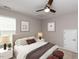 Cozy bedroom featuring neutral tones, a ceiling fan, and decorative bedside lamps creating a relaxing atmosphere at 12421 Angel Vale Pl, Durham, NC 27703