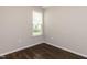 Bedroom features natural light from window, complemented by neutral walls and flooring at 12421 Angel Vale Pl, Durham, NC 27703