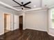 This bedroom offers a ceiling fan, neutral paint, and convenient access to an en-suite bathroom and closet at 12421 Angel Vale Pl, Durham, NC 27703