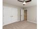 Neutral bedroom with closet, ceiling fan and carpeted floor at 12421 Angel Vale Pl, Durham, NC 27703