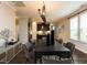 Formal dining room featuring hardwood floors, modern chandelier, and convenient access to the kitchen at 12421 Angel Vale Pl, Durham, NC 27703
