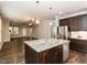 Spacious kitchen with granite counters, stainless appliances, and an open view to the living room at 12421 Angel Vale Pl, Durham, NC 27703