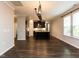 Modern kitchen with granite counters, stainless appliances, large island, and dark wood cabinets at 12421 Angel Vale Pl, Durham, NC 27703