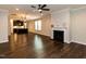 Spacious living room featuring hardwood floors, a fireplace, and seamless access to the kitchen at 12421 Angel Vale Pl, Durham, NC 27703