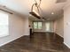 Bright living room featuring hardwood floors, a fireplace, and large windows overlooking the backyard at 12421 Angel Vale Pl, Durham, NC 27703
