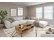 A bright living room features a large sectional sofa, modern art, and a decorative rug with an open and inviting layout at 12421 Angel Vale Pl, Durham, NC 27703
