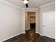 Open living space featuring hardwood floors and convenient access to the kitchen through an arched doorway at 12421 Angel Vale Pl, Durham, NC 27703