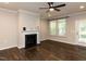 Living room with hardwood floors, a fireplace, and neutral walls, ready for your personal touches at 12421 Angel Vale Pl, Durham, NC 27703